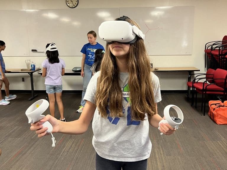 A young student using a VR headset at an outreach event